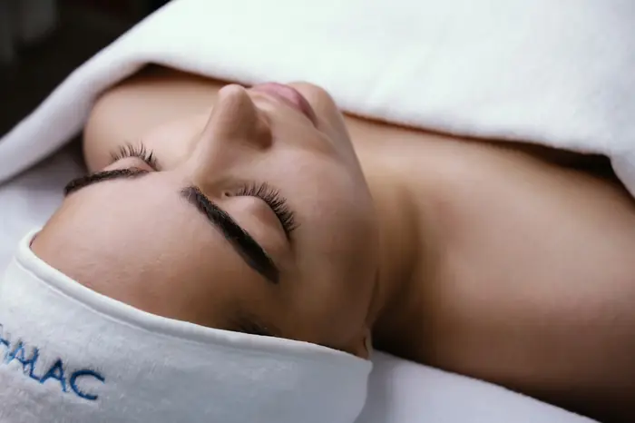 A client resting with eyes closed after a treatment